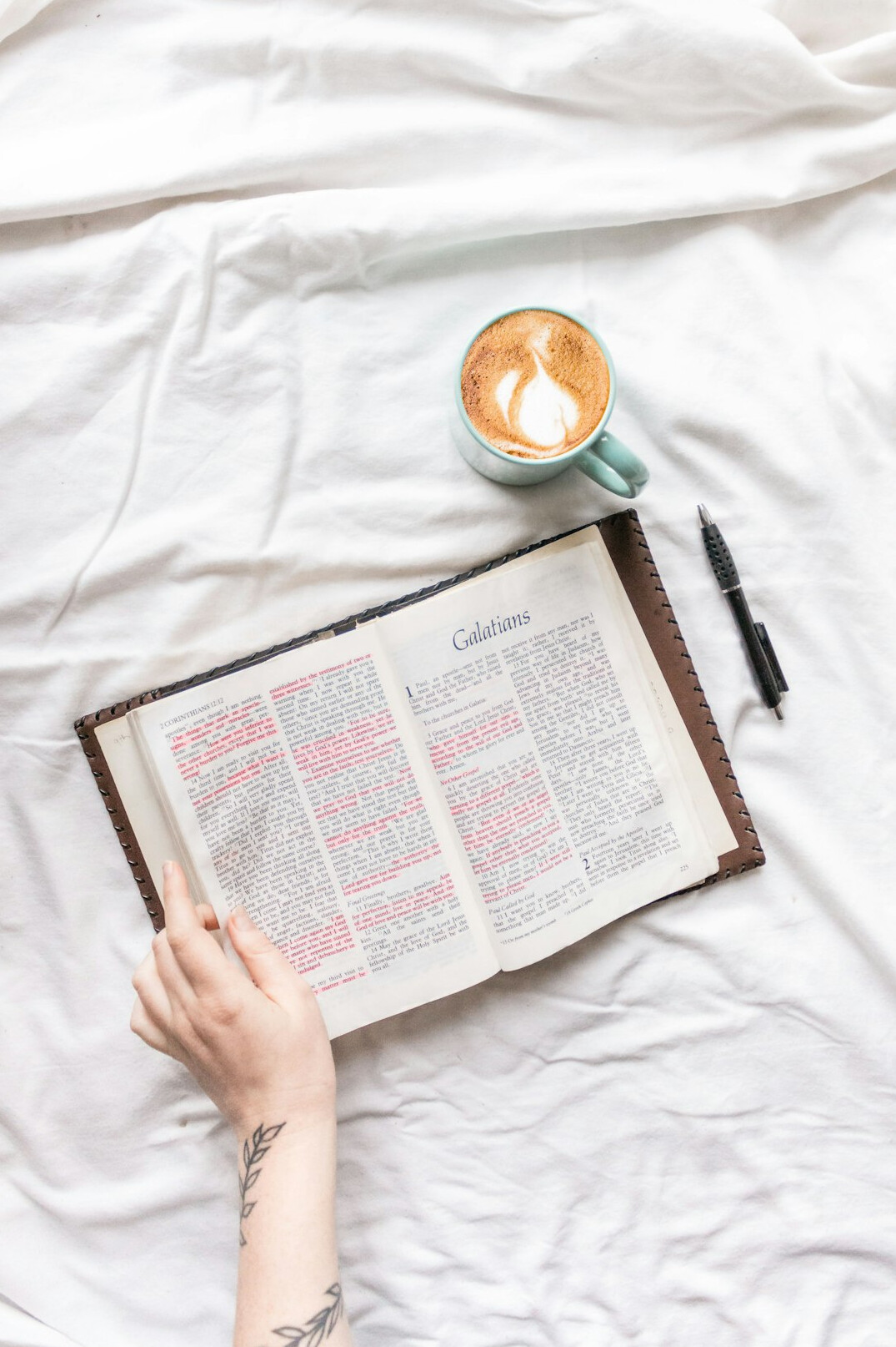 Hand writing in a notebook with a pen