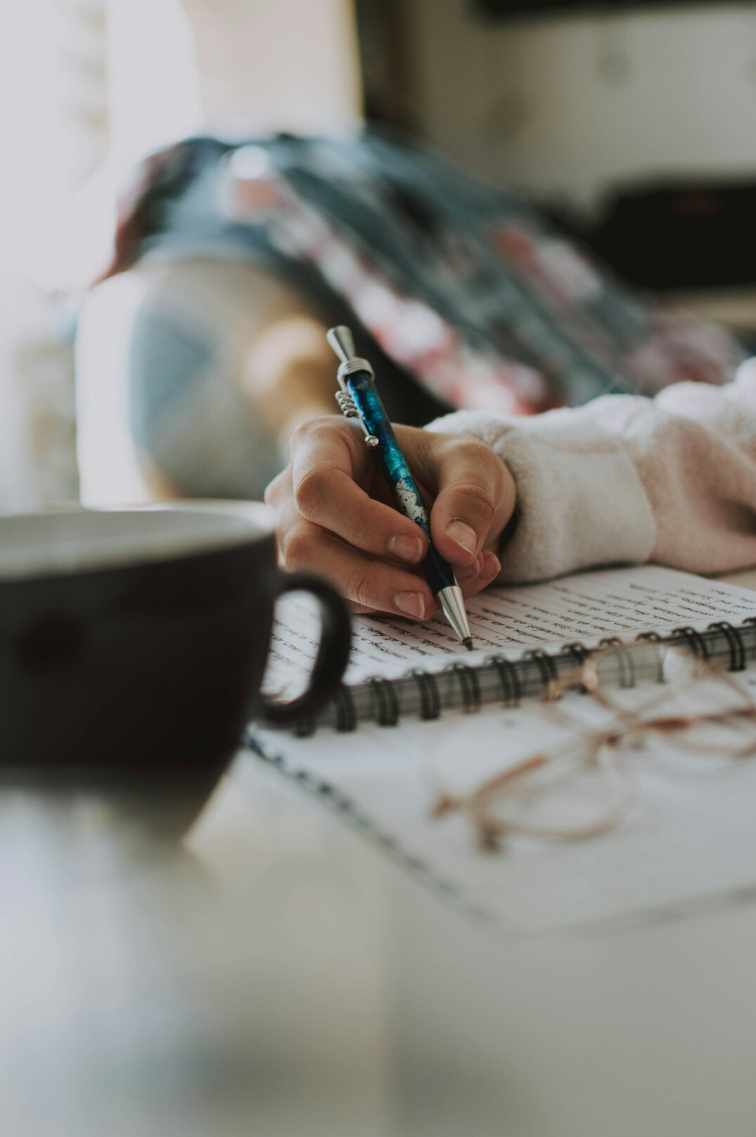person writing in journal during workshop
