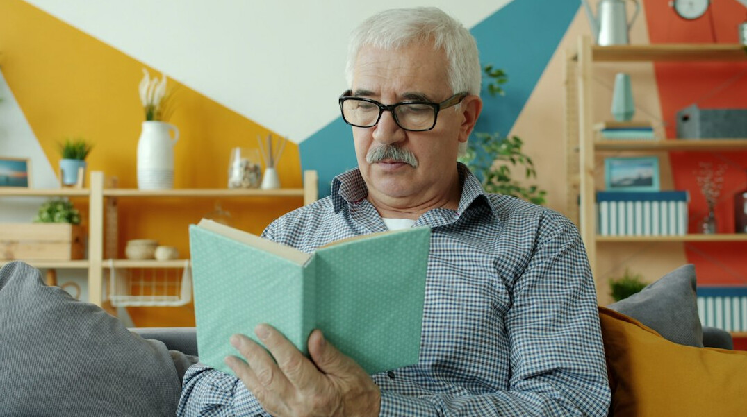 person reading book in quiet room
